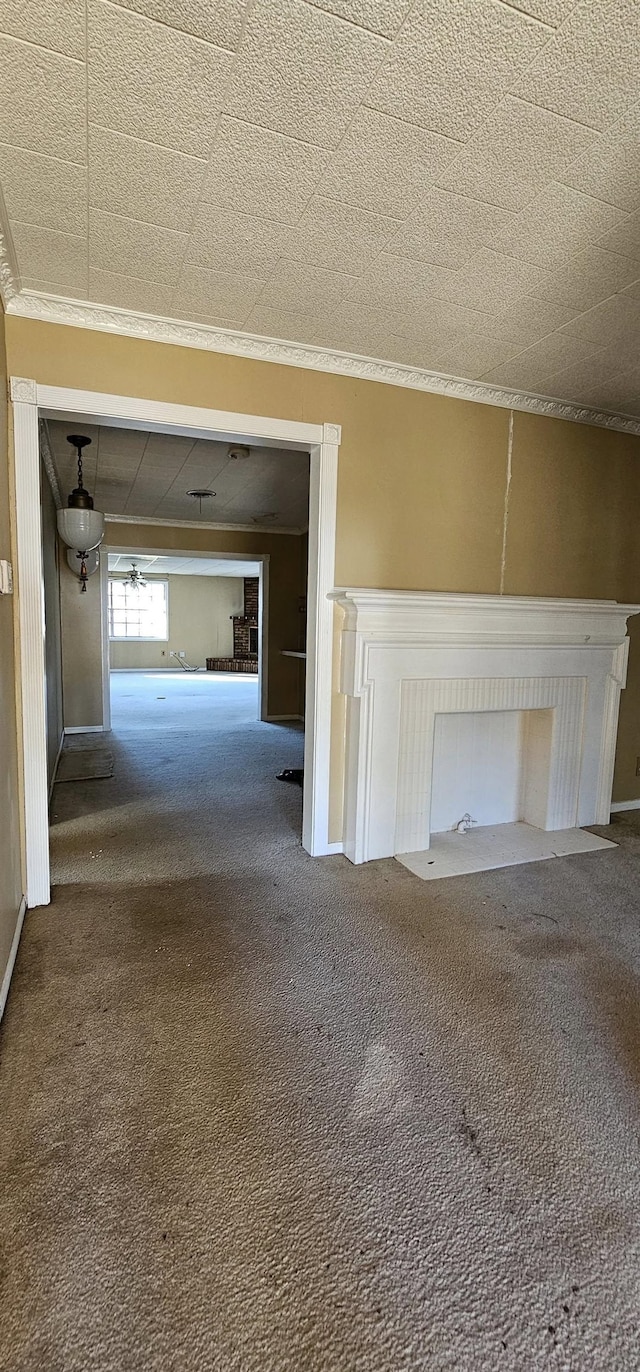 unfurnished living room with crown molding and carpet