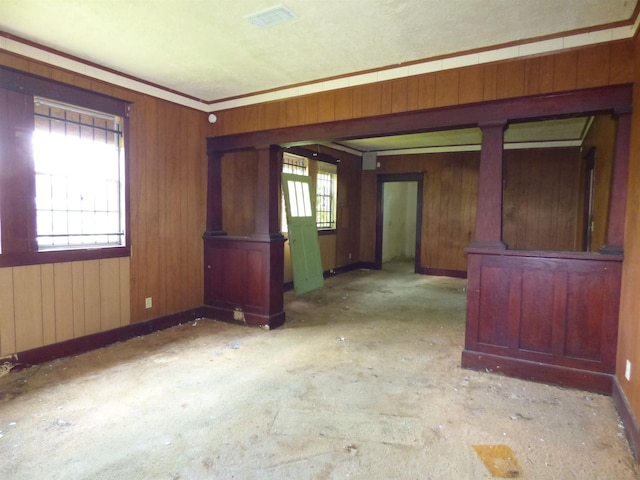 empty room featuring wooden walls