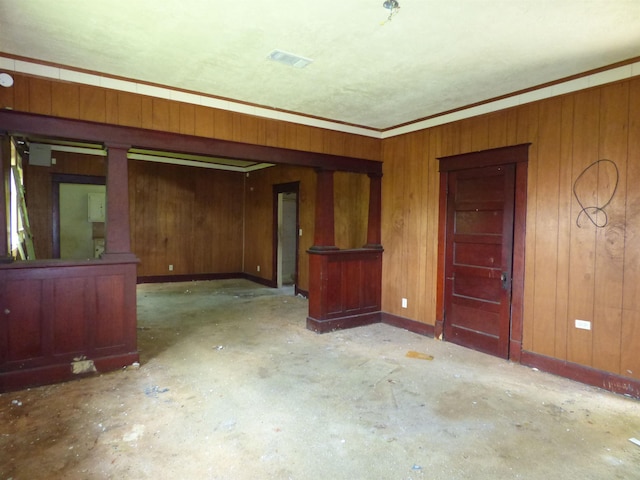 spare room with wood walls