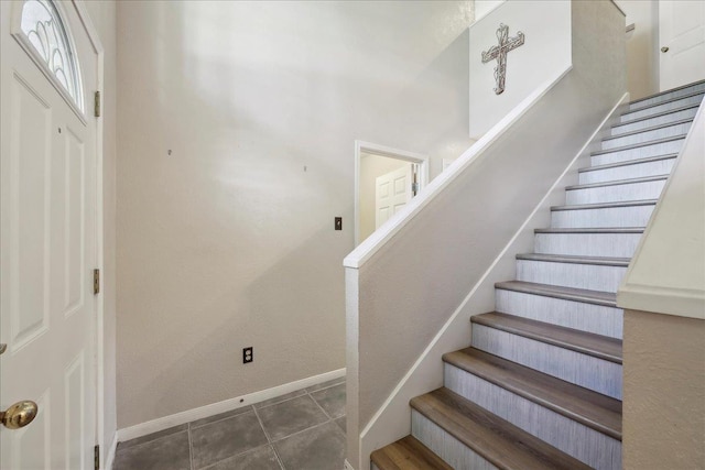 foyer with stairway and baseboards