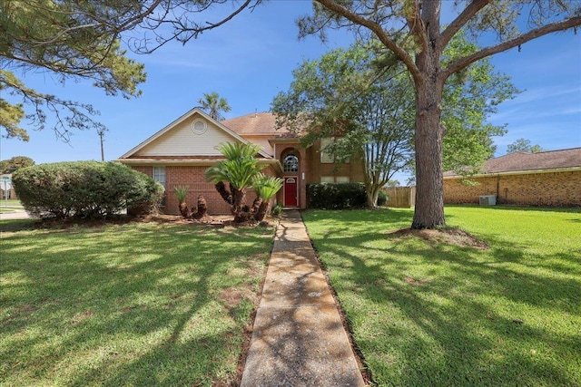 view of front of property with a front lawn and brick siding