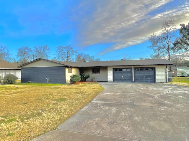 ranch-style home with a front yard and a garage