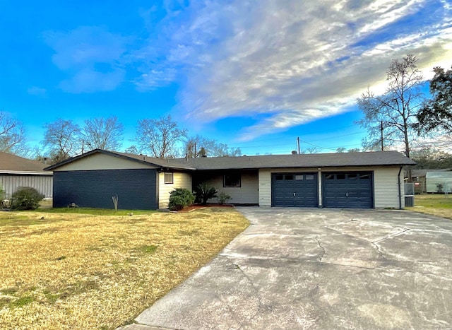 ranch-style home with a front yard and a garage