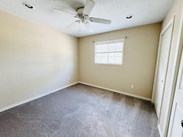 unfurnished bedroom with ceiling fan, carpet, and a textured ceiling