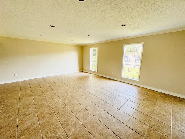 tiled empty room featuring a textured ceiling and crown molding