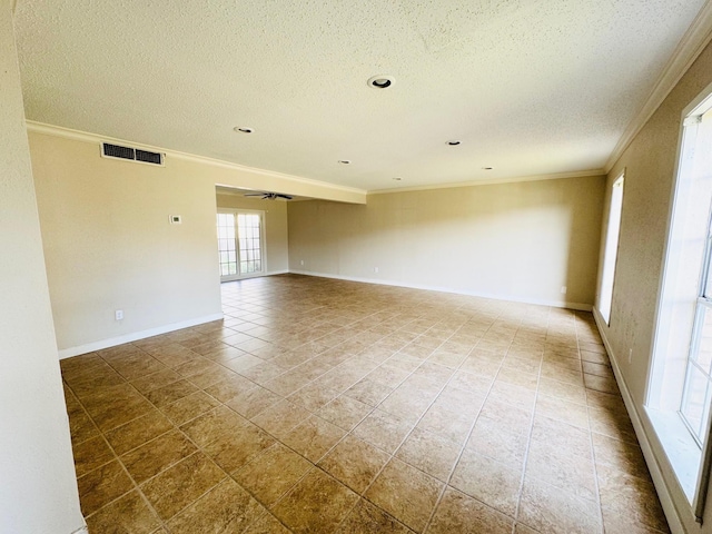 unfurnished room featuring tile patterned flooring, ceiling fan, ornamental molding, and a textured ceiling