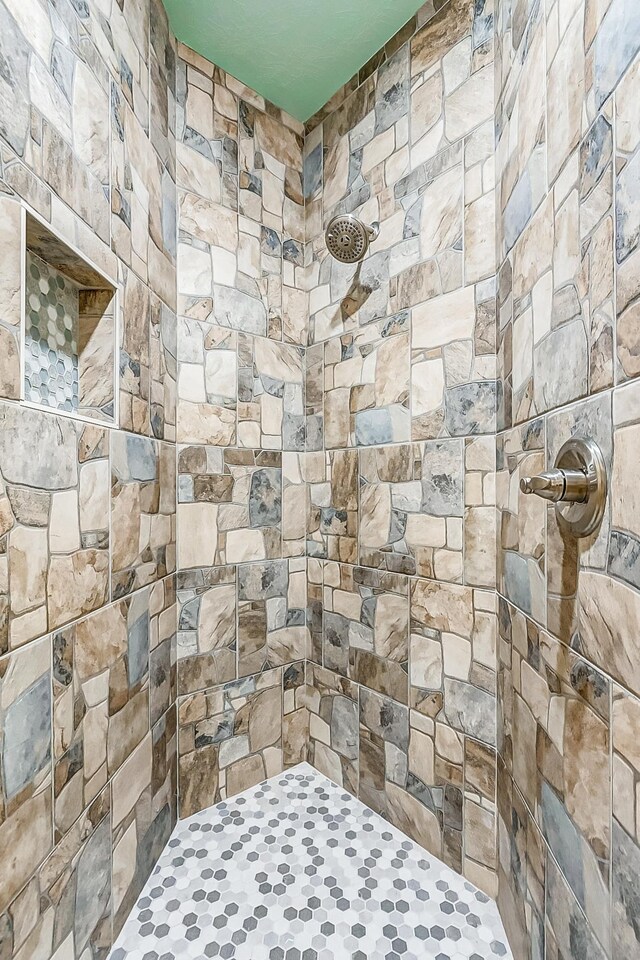 bathroom with a tile shower