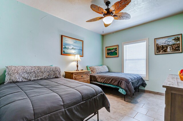 tiled bedroom with ceiling fan