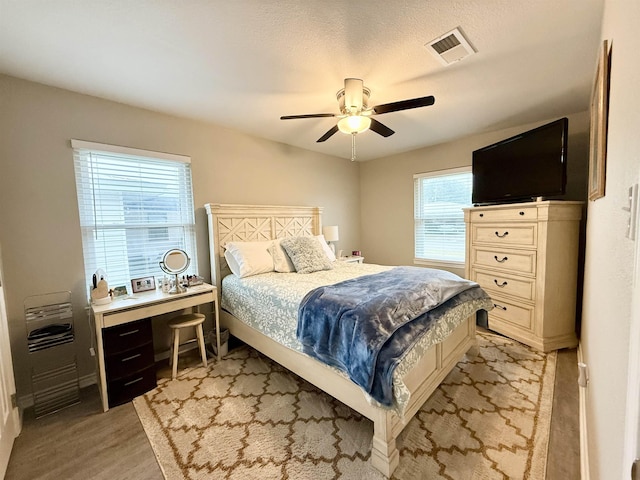 bedroom with ceiling fan and light hardwood / wood-style floors