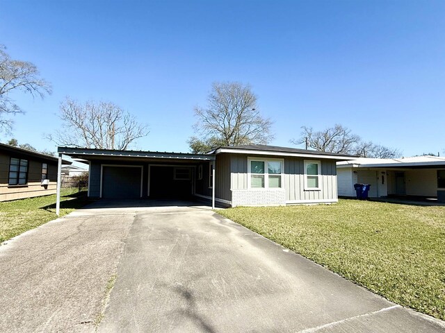 single story home featuring a garage and a front yard