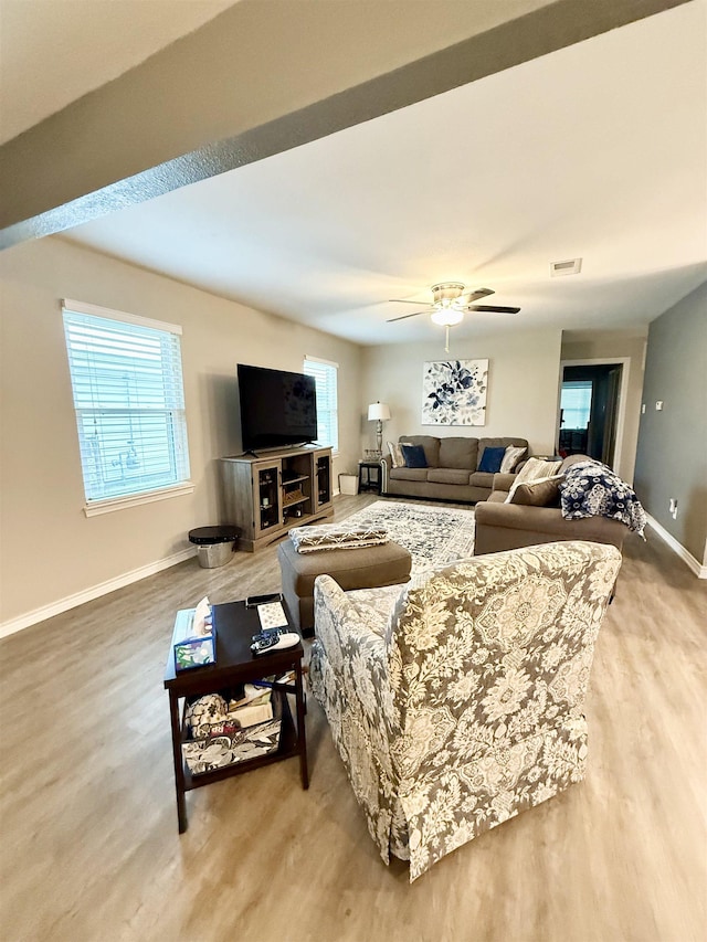 living room featuring hardwood / wood-style flooring and ceiling fan