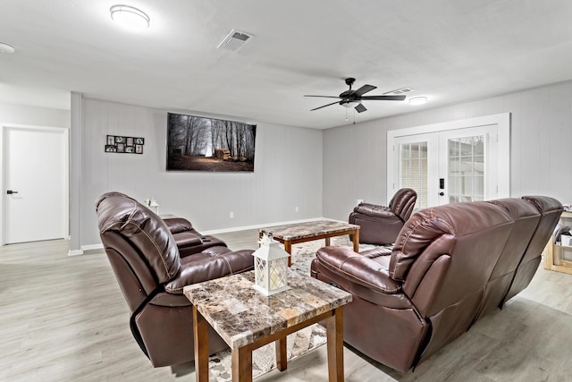 living room with ceiling fan, french doors, and light hardwood / wood-style floors