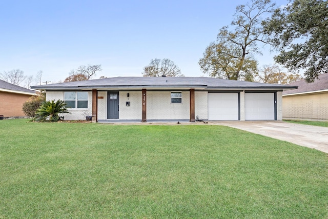 single story home featuring a front yard, a garage, and covered porch