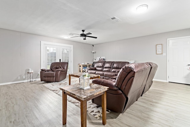 living room featuring ceiling fan, french doors, and light hardwood / wood-style floors