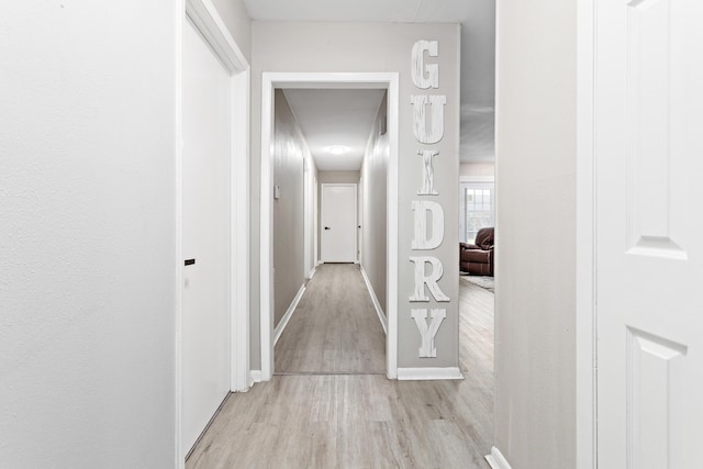 hallway with light hardwood / wood-style flooring