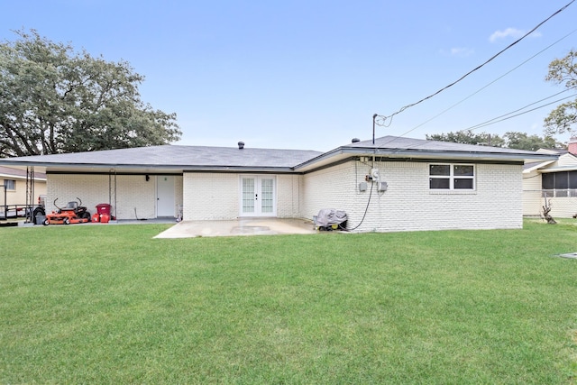 back of house with a lawn, a patio area, and french doors