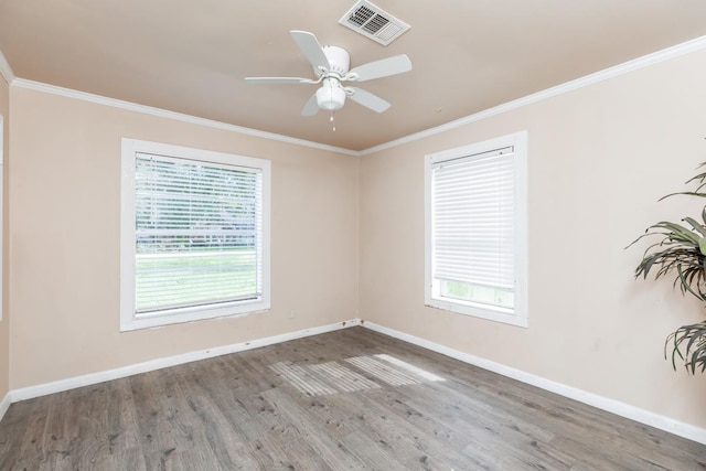 empty room featuring ceiling fan, wood-type flooring, crown molding, and a wealth of natural light