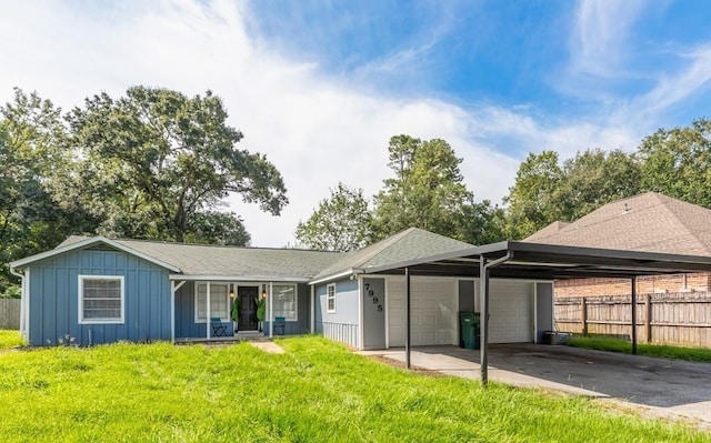 rear view of house with a carport and a lawn