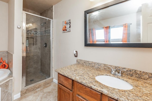 bathroom with tile patterned floors, vanity, and plus walk in shower