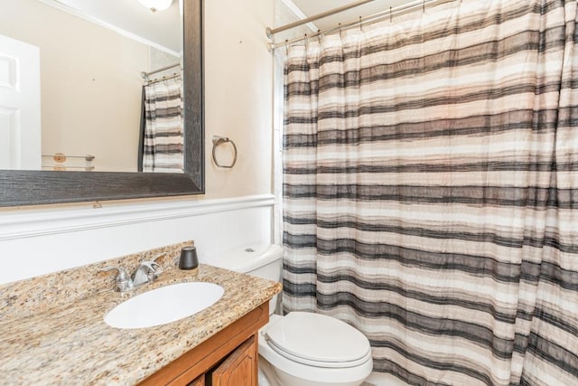 bathroom with a shower with curtain, vanity, toilet, and ornamental molding