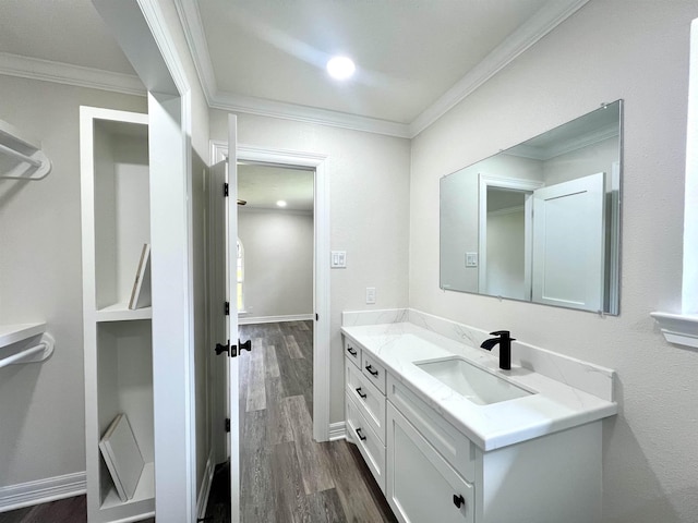 bathroom featuring hardwood / wood-style floors, vanity, and ornamental molding