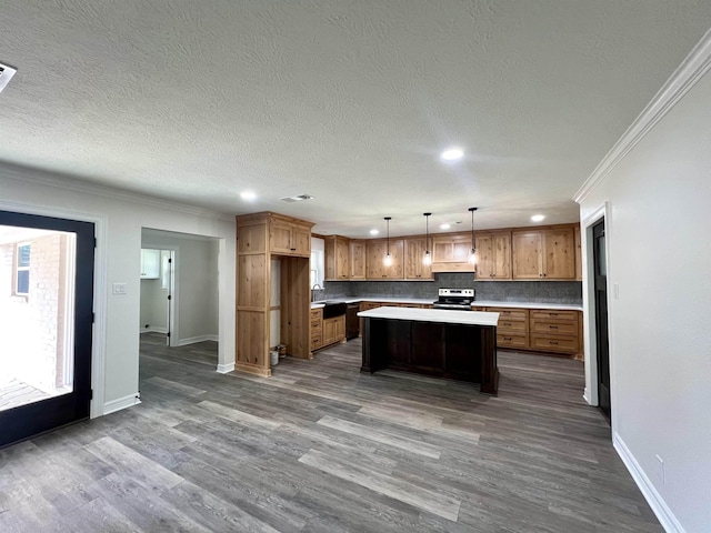 kitchen featuring tasteful backsplash, crown molding, electric range, a kitchen island, and hanging light fixtures