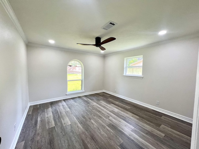 spare room with crown molding, ceiling fan, and dark wood-type flooring