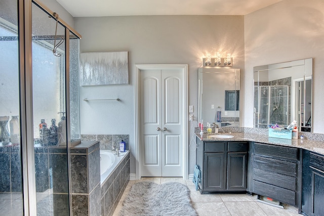 bathroom featuring tile patterned flooring, vanity, and separate shower and tub