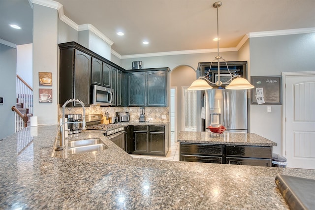 kitchen with decorative backsplash, dark stone countertops, ornamental molding, appliances with stainless steel finishes, and decorative light fixtures