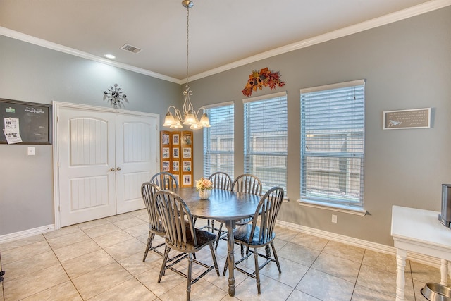 dining room featuring light tile patterned flooring, crown molding, and an inviting chandelier