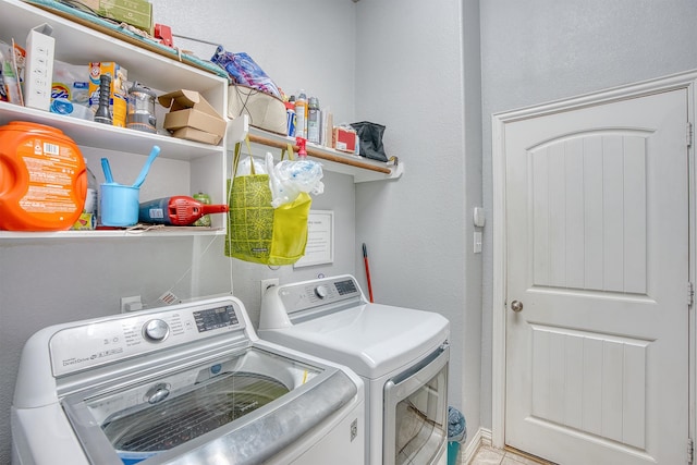 laundry room featuring light tile patterned floors and washing machine and dryer