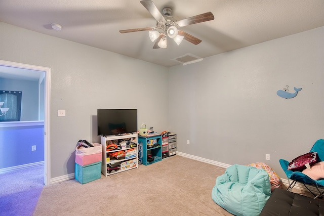 rec room with carpet flooring and ceiling fan