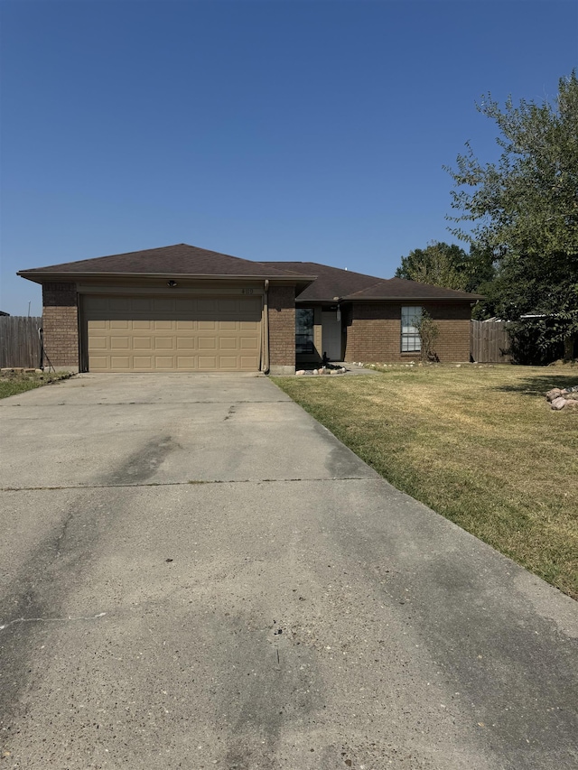 view of front of property featuring a garage and a front yard