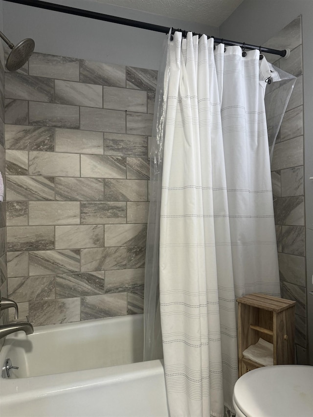 bathroom with shower / bathtub combination with curtain and toilet