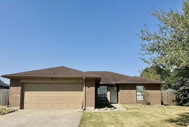 single story home featuring a front yard and a garage