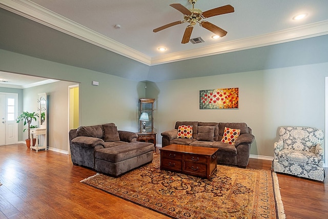 living area with a ceiling fan, baseboards, ornamental molding, and wood finished floors