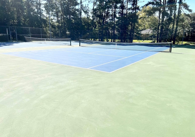 view of tennis court with fence