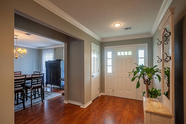 entrance foyer featuring dark wood-type flooring, visible vents, and crown molding