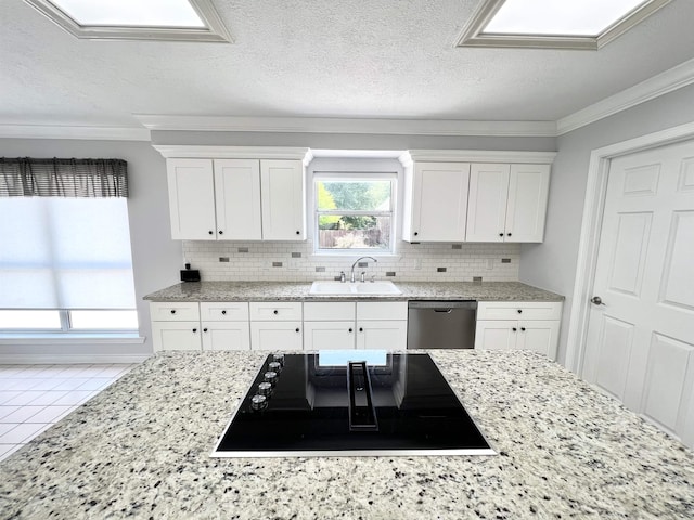 kitchen with dishwasher, a sink, black electric cooktop, and crown molding