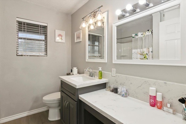 bathroom with vanity, wood-type flooring, curtained shower, and toilet