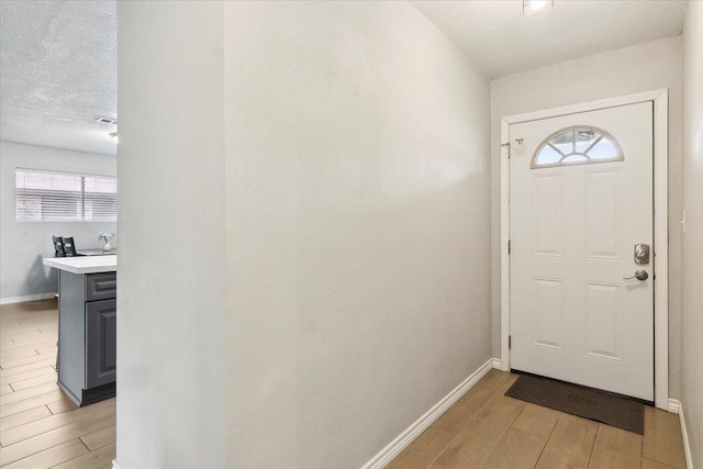 entryway with a textured ceiling