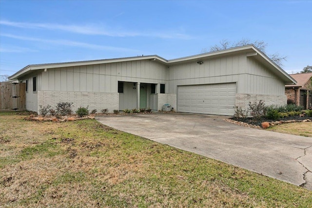 ranch-style house featuring a garage and a front lawn