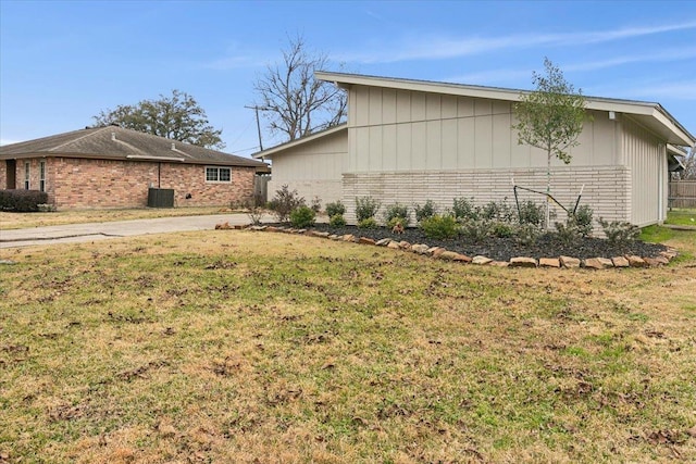 view of side of property with a yard