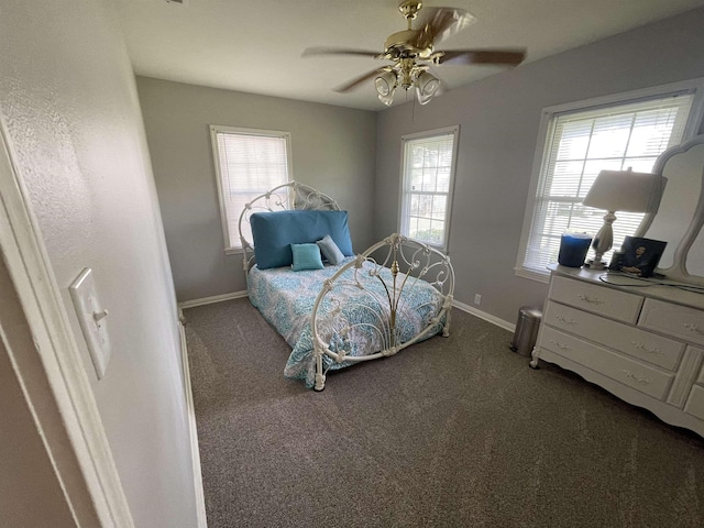 carpeted bedroom with multiple windows and ceiling fan