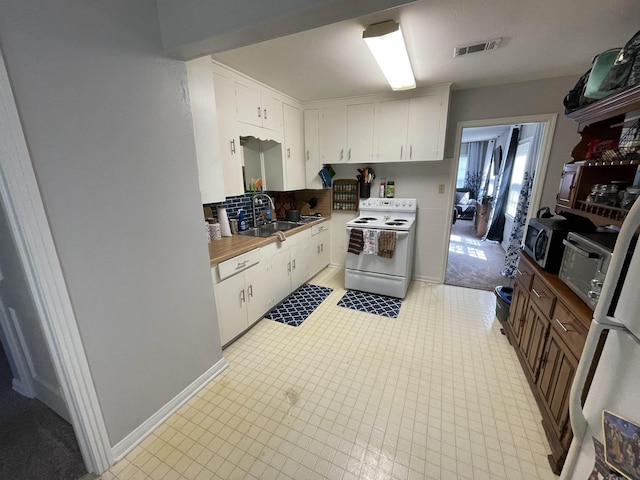 kitchen featuring white cabinets, white range with electric stovetop, and sink