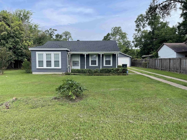 view of front of property with a front lawn and a garage