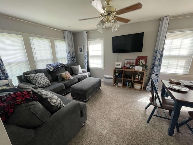 carpeted living room featuring ceiling fan