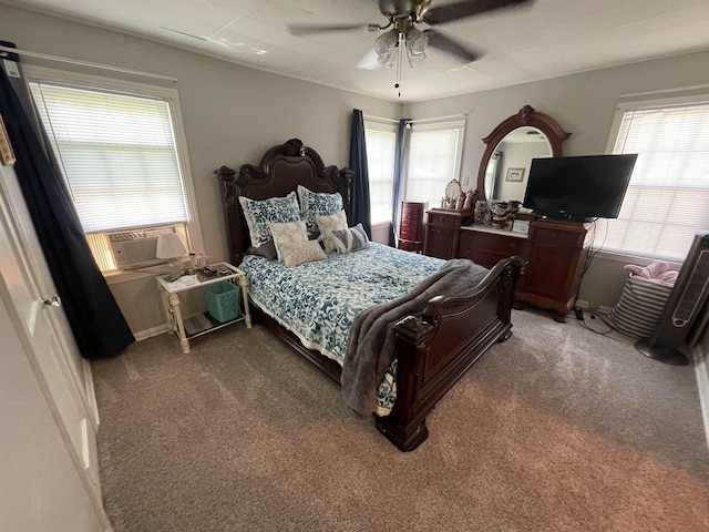 bedroom featuring dark colored carpet, ceiling fan, and cooling unit