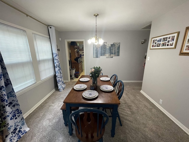 dining area featuring carpet floors and an inviting chandelier