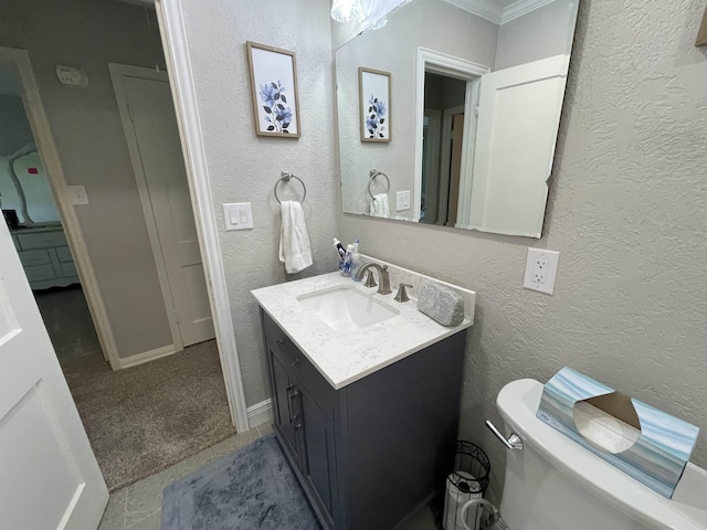 bathroom featuring vanity, toilet, and crown molding